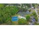 Stunning aerial view of community amenities including a pool, tennis courts, and a picturesque pond at 92 Creek Front Way, Lawrenceville, GA 30043