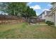 The backyard has a patio with a grill, a lawn and a wood fence at 92 Creek Front Way, Lawrenceville, GA 30043