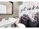 Cozy bathroom featuring modern fixtures, a trendy patterned wall, and a unique shower curtain at 92 Creek Front Way, Lawrenceville, GA 30043