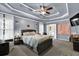 This main bedroom has a trey ceiling, fan and an ensuite bathroom through double doors at 92 Creek Front Way, Lawrenceville, GA 30043
