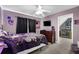 The bedroom has a bed, dresser, television, and fan at 92 Creek Front Way, Lawrenceville, GA 30043