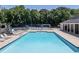 Large community pool features ample lounge seating and a nearby playground and tennis court for recreation at 92 Creek Front Way, Lawrenceville, GA 30043