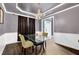 Elegant dining room featuring modern lighting, beautiful dark floors, and a glass table that create an inviting atmosphere at 92 Creek Front Way, Lawrenceville, GA 30043