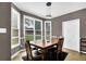 Cozy dining room with a wooden table, black rug, natural lighting, and modern light fixture at 92 Creek Front Way, Lawrenceville, GA 30043