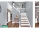 Inviting entryway showcasing a staircase with white spindles and a black handrail at 92 Creek Front Way, Lawrenceville, GA 30043