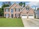 Charming two-story brick home with a well-manicured lawn and a two-car garage at 92 Creek Front Way, Lawrenceville, GA 30043