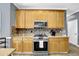 Spacious kitchen with light wood cabinets, modern appliances, and tiled backsplash at 92 Creek Front Way, Lawrenceville, GA 30043