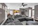 Open-concept living room with hardwood floors, an oversized sectional sofa, and modern decor at 92 Creek Front Way, Lawrenceville, GA 30043