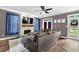 Comfortable living room featuring hardwood floors, a stone fireplace, and backyard access through a glass door at 92 Creek Front Way, Lawrenceville, GA 30043