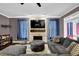 Relaxing living room with a stone fireplace, mounted TV, and comfortable, oversized furniture at 92 Creek Front Way, Lawrenceville, GA 30043