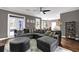 Inviting living room with hardwood floors, an oversized sectional sofa, a fan, and backyard access at 92 Creek Front Way, Lawrenceville, GA 30043