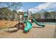 Community playground includes a slide, swings, and stairs and nearby tennis court for Gathering enjoyment at 92 Creek Front Way, Lawrenceville, GA 30043