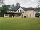 Expansive backyard featuring a well-maintained lawn and a traditional two-story brick home at 2728 Talley Ln, Buford, GA 30519