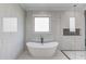 Contemporary bathroom featuring soaking tub, walk-in shower and sleek, modern design at 2728 Talley Ln, Buford, GA 30519