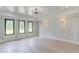Light filled main bedroom with large windows, recessed lights, and paneled accent wall at 2728 Talley Ln, Buford, GA 30519