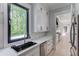Bright kitchen with an oversized window, stainless steel appliances, and custom cabinets at 2728 Talley Ln, Buford, GA 30519