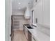 Modern kitchen featuring white cabinets, a stainless fridge, and an elongated island with a black sink at 2728 Talley Ln, Buford, GA 30519