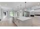 Open-concept kitchen with a large island, stainless steel appliances, and modern lighting fixtures at 2728 Talley Ln, Buford, GA 30519