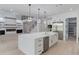 Bright kitchen island with stainless dishwasher and sink in an open concept kitchen and living area at 2728 Talley Ln, Buford, GA 30519