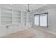 Office with custom built-in bookshelves and cabinets, and large window with blinds at 2728 Talley Ln, Buford, GA 30519