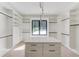 Spacious walk-in closet with custom shelving, storage, and center island with drawers at 2728 Talley Ln, Buford, GA 30519