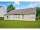 A charming tan single story home with a well-manicured lawn and a bright sky at 7105 Boulder Pass, Union City, GA 30291