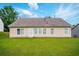 A lovely backyard featuring a tan single story home with a well-manicured lawn and a bright sky at 7105 Boulder Pass, Union City, GA 30291