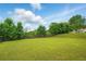 An expansive backyard featuring a well-maintained lawn, mature trees, and a classic wooden fence at 7105 Boulder Pass, Union City, GA 30291