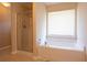 Bright bathroom features a tub next to a glass enclosed shower and a large window at 7105 Boulder Pass, Union City, GA 30291