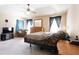 Large bedroom featuring an accent wall, ceiling fan, dresser with mirror, and a TV at 7105 Boulder Pass, Union City, GA 30291