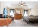 Spacious bedroom boasts vaulted ceilings, a ceiling fan, and a wooden dresser with mirror at 7105 Boulder Pass, Union City, GA 30291