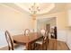 Elegant dining room featuring a chandelier, wainscoting, and a dark wood table with seating at 7105 Boulder Pass, Union City, GA 30291