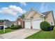 Attractive home featuring brick and tan siding, a well-maintained lawn, and a convenient two-car garage at 7105 Boulder Pass, Union City, GA 30291
