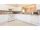 Bright kitchen with white cabinets, tile countertops, and essential appliances for a functional cooking space at 7105 Boulder Pass, Union City, GA 30291
