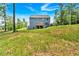 Home exterior with a large grassy backyard and patio at 7474 Waterview Cv, Douglasville, GA 30135