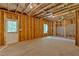 Unfinished basement with exposed wood framing and a door to the outside at 7474 Waterview Cv, Douglasville, GA 30135