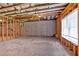 Unfinished basement featuring exposed rafters and a window at 7474 Waterview Cv, Douglasville, GA 30135