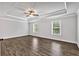 Spacious bedroom with wood flooring, ceiling fan, and windows offering natural light at 7474 Waterview Cv, Douglasville, GA 30135