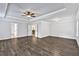 Spacious bedroom featuring tray ceilings, wood floors, recessed lighting, and multiple doorways at 7474 Waterview Cv, Douglasville, GA 30135