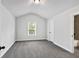 A bedroom showcasing plush carpeting, an overhead light, and a door leading to the ensuite at 7474 Waterview Cv, Douglasville, GA 30135