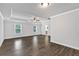 Bright bedroom featuring wood flooring, a ceiling fan, and two large windows at 7474 Waterview Cv, Douglasville, GA 30135