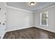 Empty bedroom with grey walls and hardwood floors at 7474 Waterview Cv, Douglasville, GA 30135