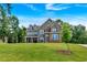 Beautiful brick two-story home featuring dormer windows and a well manicured lawn at 7474 Waterview Cv, Douglasville, GA 30135