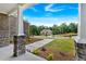 View of the home from the front porch featuring stone pillars and landscaping at 7474 Waterview Cv, Douglasville, GA 30135