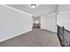 Second-floor hallway with carpet featuring decorative iron railing overlooking the stairs at 7474 Waterview Cv, Douglasville, GA 30135
