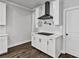 Bright kitchen nook featuring white shaker cabinets and stainless steel range hood over an induction cooktop at 7474 Waterview Cv, Douglasville, GA 30135