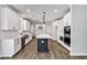 This spacious kitchen features white cabinets, stainless steel appliances, and a large island with a breakfast bar at 7474 Waterview Cv, Douglasville, GA 30135