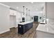 Gorgeous kitchen with island, white cabinets, stainless appliances, and access to the living room at 7474 Waterview Cv, Douglasville, GA 30135