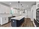 Modern kitchen with white cabinets, navy island, stainless steel appliances, and pendant lighting at 7474 Waterview Cv, Douglasville, GA 30135
