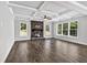 Bright living room features coffered ceilings, wood floors, stone fireplace, and large windows at 7474 Waterview Cv, Douglasville, GA 30135